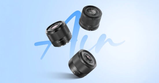 Three camera lenses are floating against a light blue background with a stylized "Air" text in the middle. The lenses are positioned in different angles, showcasing their glass elements and metallic finishes.