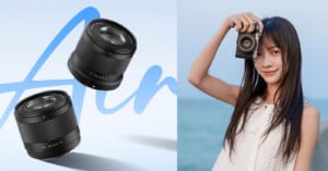 A woman with long hair smiles while holding a camera up to her eye. On the left, there are two camera lenses floating against a light blue background.